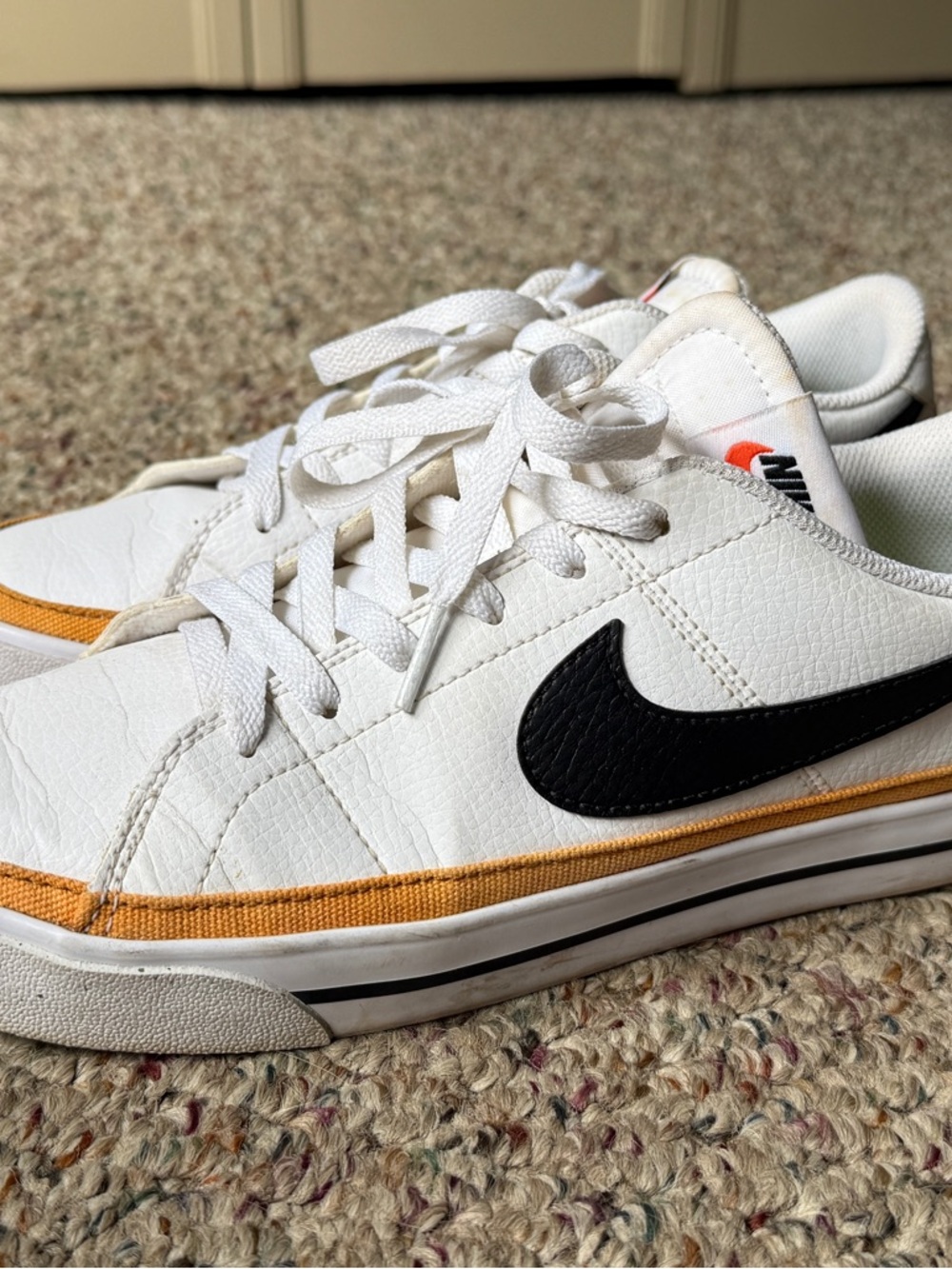 Nike Men’s White Sneakers with Black Swoosh and Gold Trim